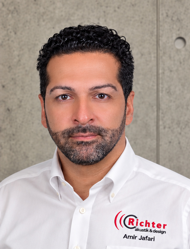 Amir Jafari poses confidently in a white shirt with the Richter logo against a concrete background.