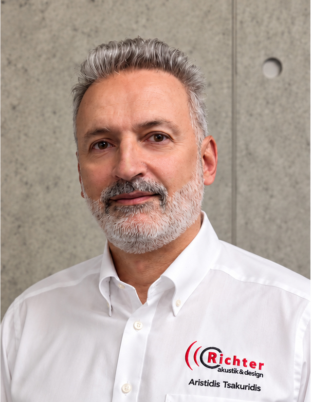 Aristidis Tsakuridis poses confidently in a crisp white shirt with Richter branding against a concrete backdrop.